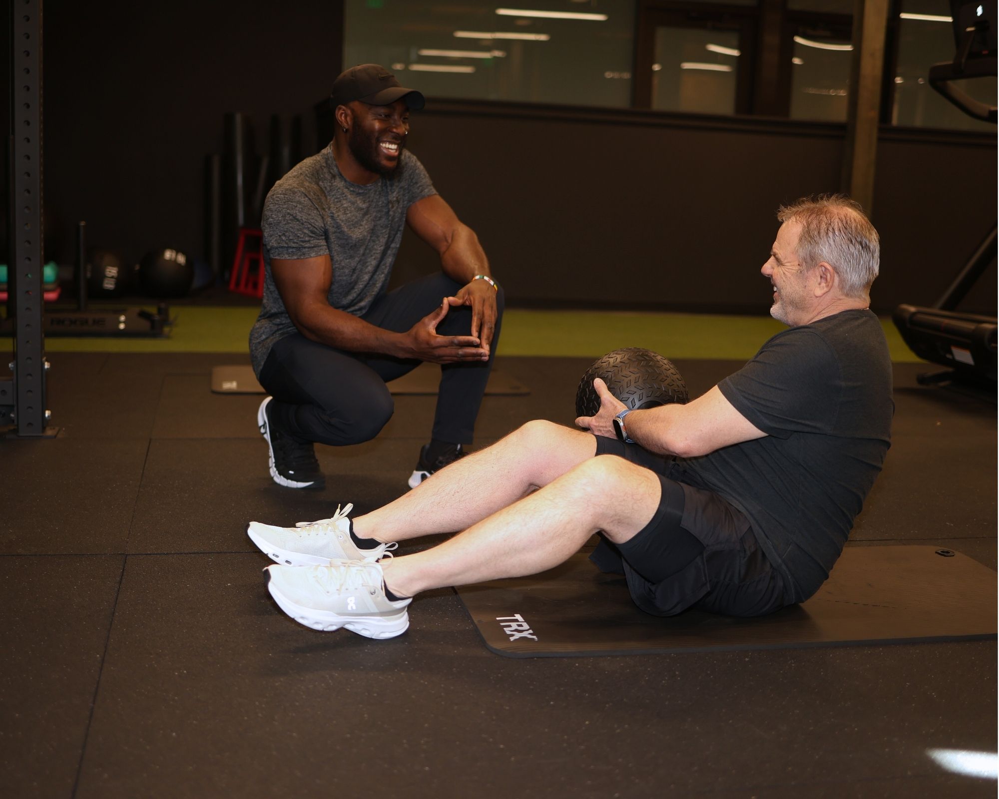 Denver personal trainer coaching and motivating a client through a strength training session.