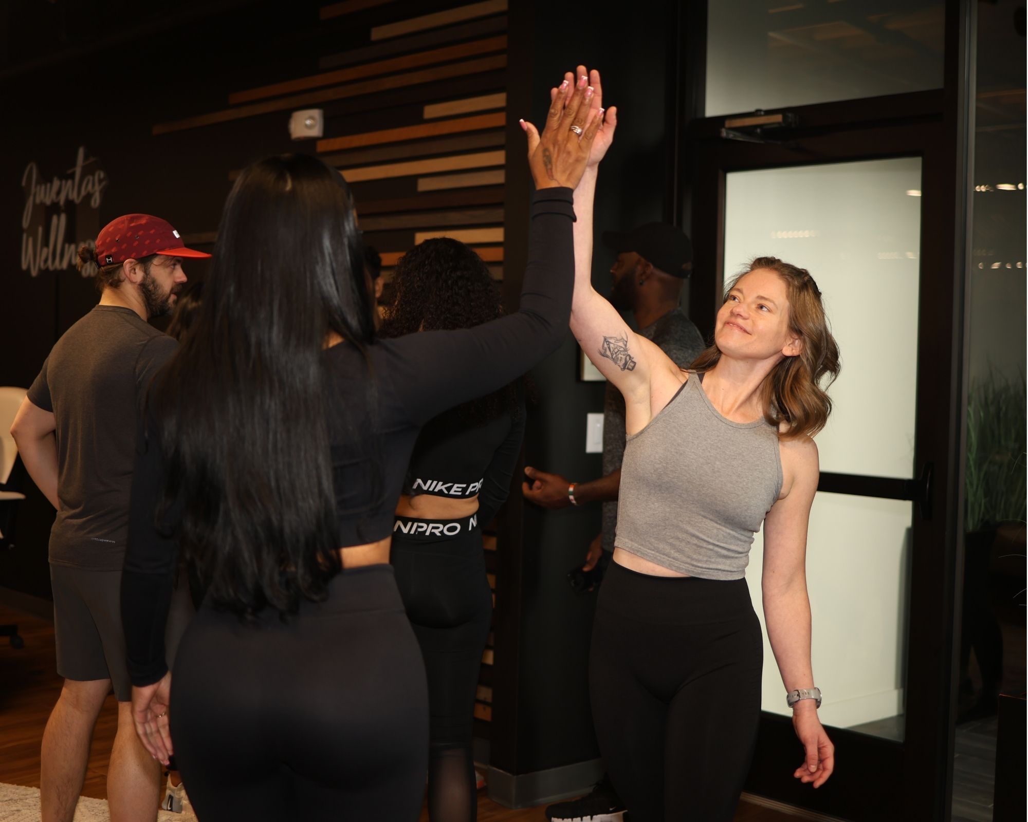 Client high-fiving their Denver personal trainer after a successful workout session.