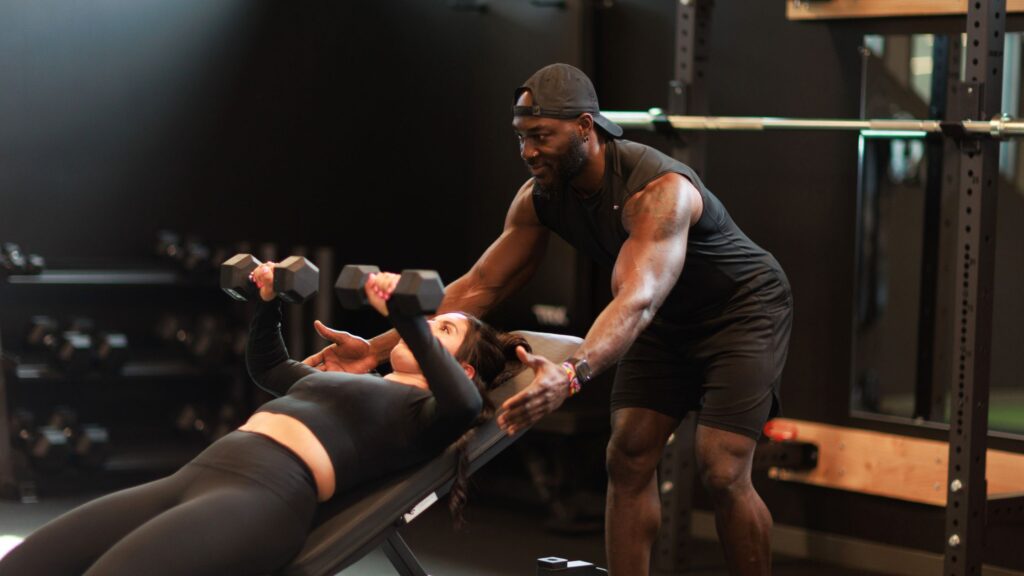Denver personal trainer coaching a client during a strength training workout.